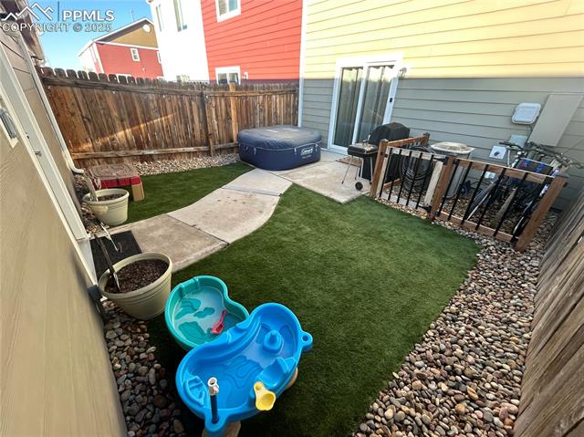 6382 Pilgrimage Road Colorado Springs, CO 80925 - Photo 29 of 32 View of patio area and a fenced backyard