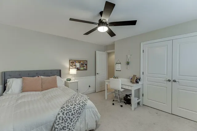 a bedroom with a bed and a chandelier