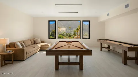 a view of a house with swimming pool and sitting area
