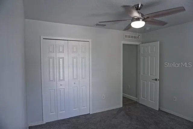 an empty room with closet and wooden floor