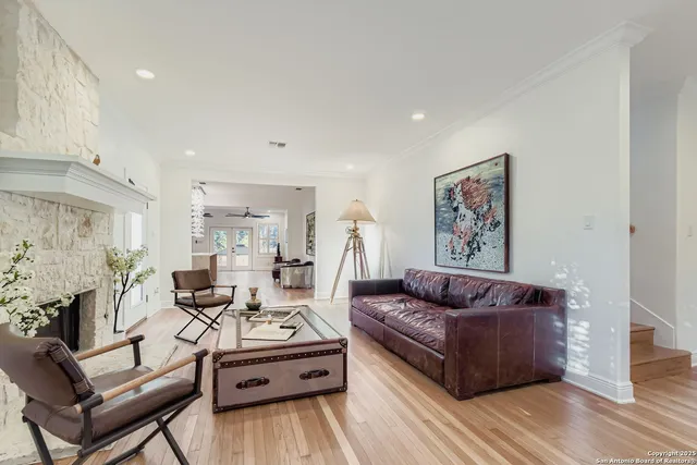 a living room with furniture and wooden floor