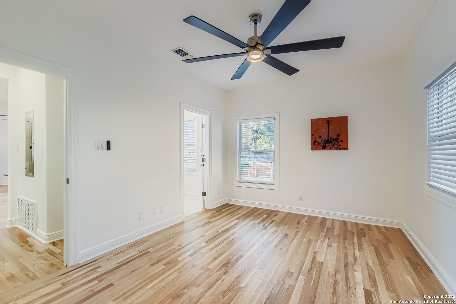 211 Elizabeth Road Terrell Hills, TX 78209 - Photo 13 of 29 a view of a room with wooden floor and a ceiling fan
