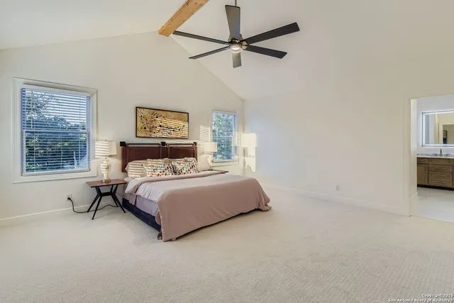 a spacious bedroom with a bed and a window