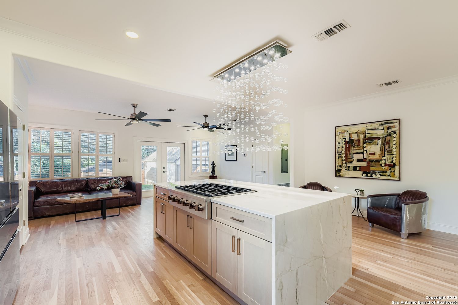 211 Elizabeth Road Terrell Hills, TX 78209 - Photo 6 of 29 a view of a kitchen counter space a sink wooden floor and windows