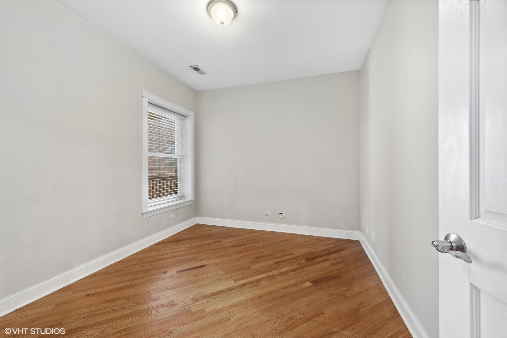 1016 Main Street, Unit 2 Evanston, IL 60202 - Photo 12 of 18 an empty room with wooden floor and windows