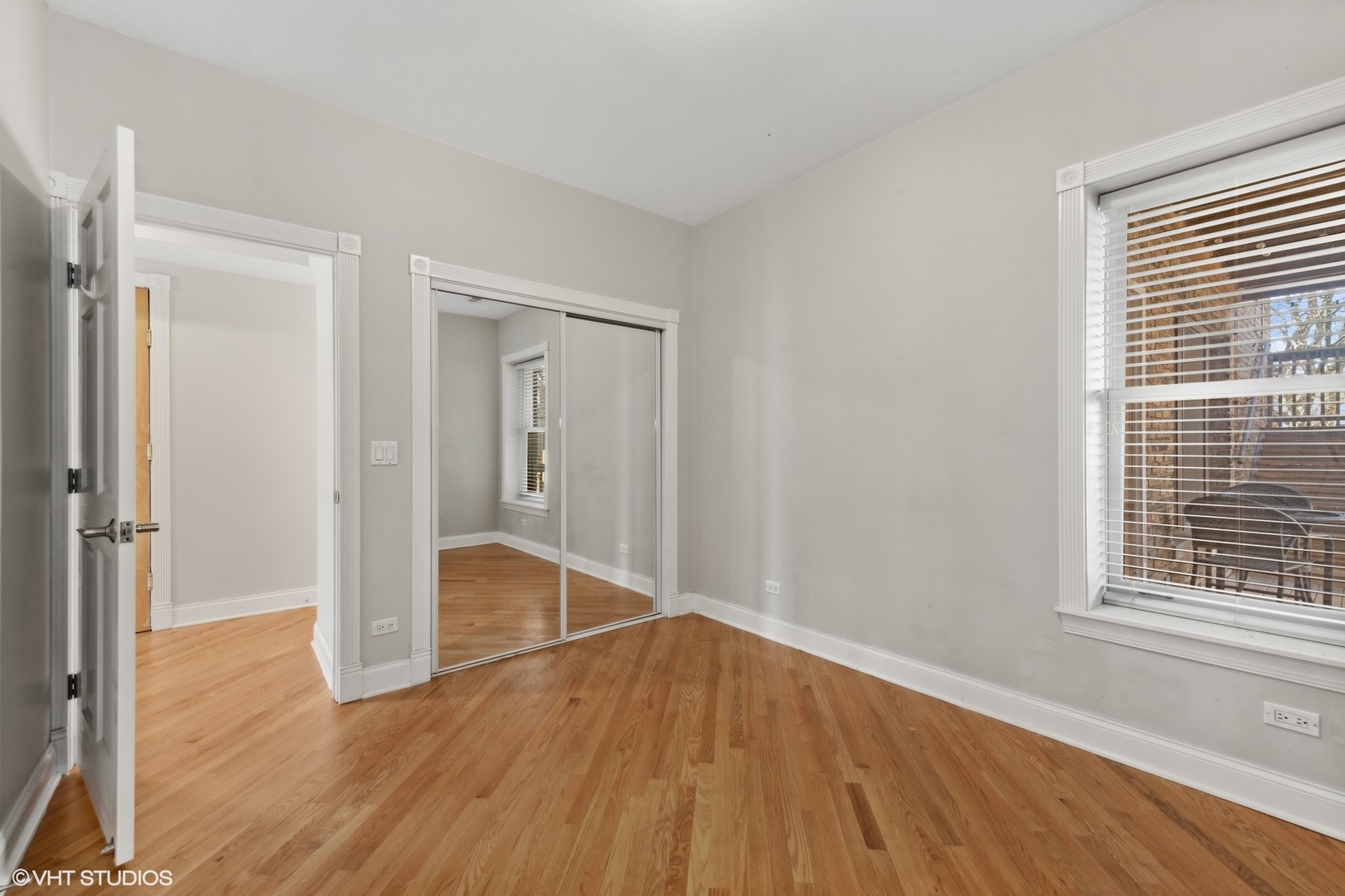 1016 Main Street, Unit 2 Evanston, IL 60202 - Photo 13 of 18 a view of empty room with wooden floor and window
