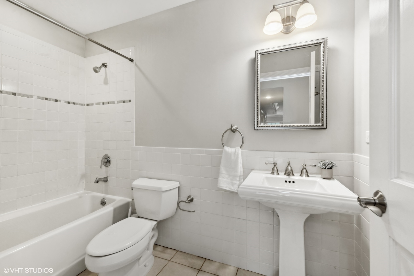 1016 Main Street, Unit 2 Evanston, IL 60202 - Photo 14 of 18 a bathroom with a sink toilet and shower