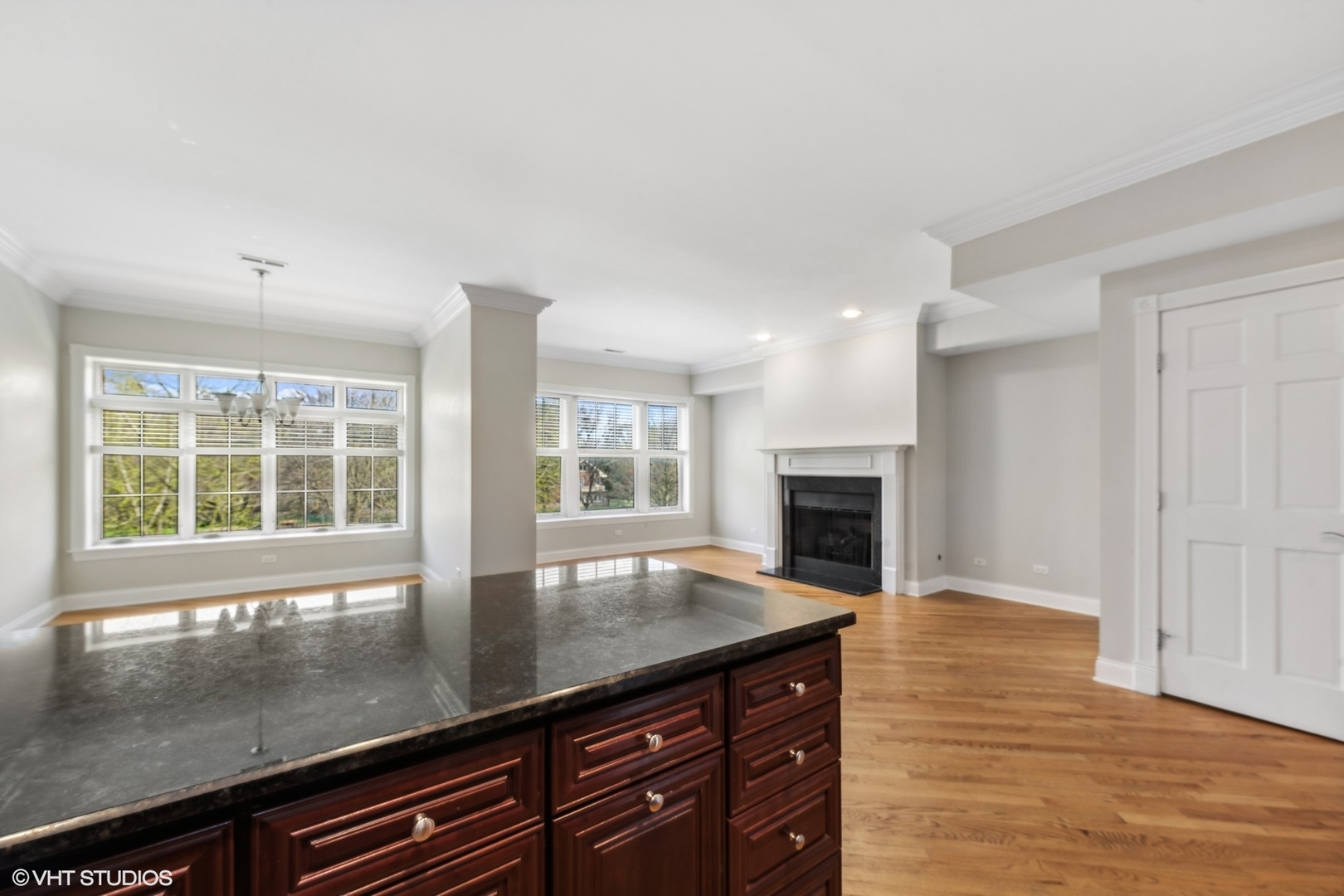 1016 Main Street, Unit 2 Evanston, IL 60202 - Photo 8 of 18 an open kitchen with granite countertop a stove and a large window