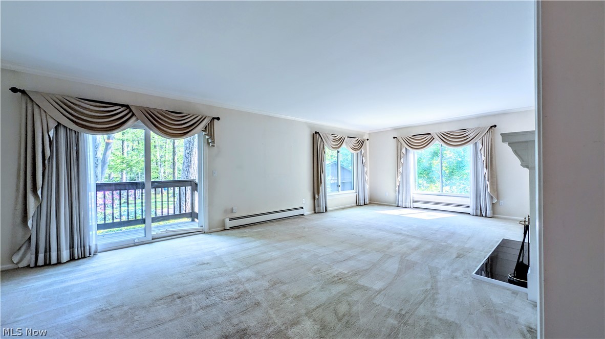 6409 Old Woods Road Ashtabula, OH 44004 - Photo 14 of 43 Spacious living area featuring light-toned carpeting and multiple windows offering abundant natural light