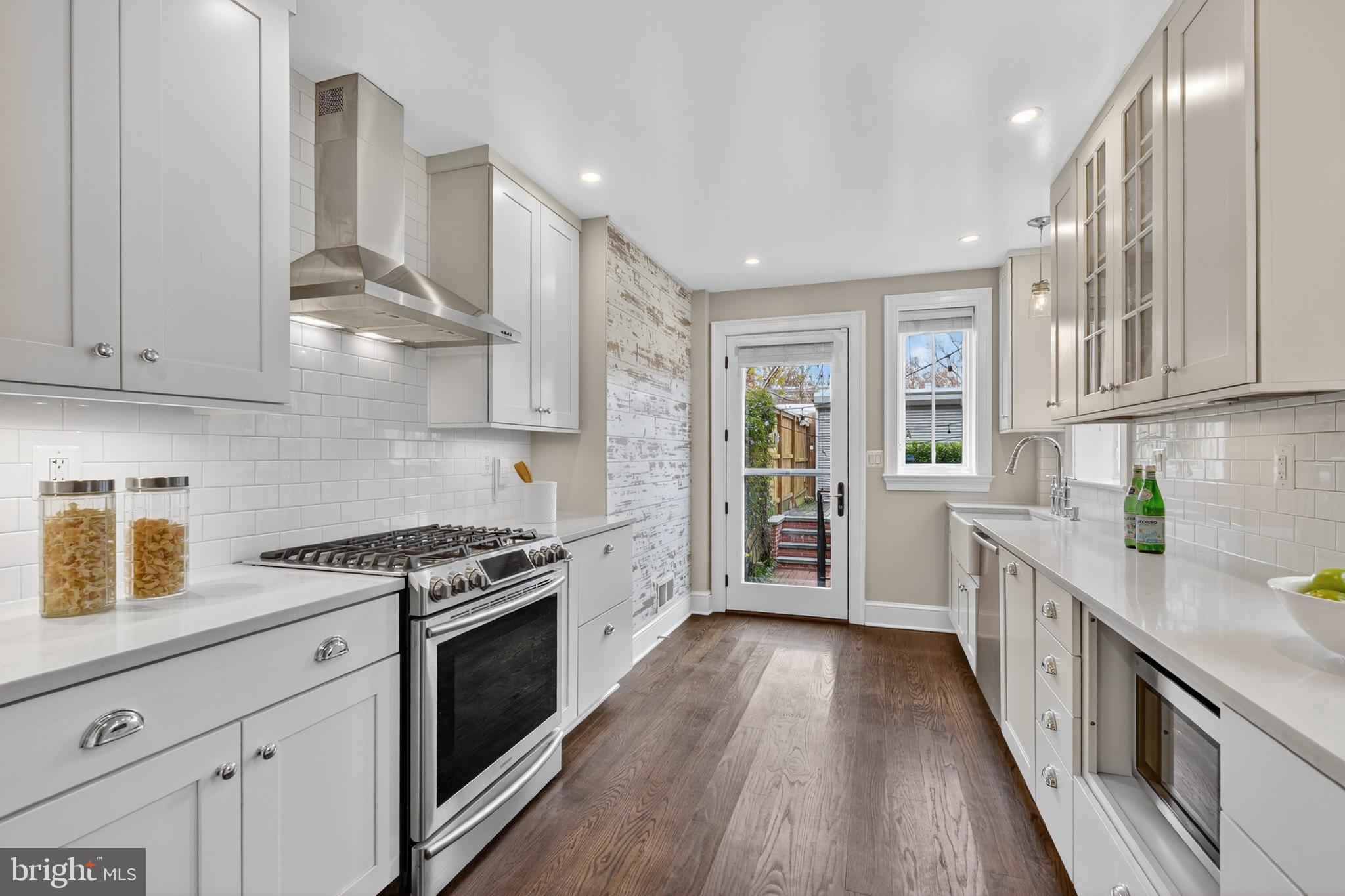 114 4th Street Northeast Washington, DC 20002 - Photo 11 of 40 a kitchen with stainless steel appliances granite countertop a stove and a sink