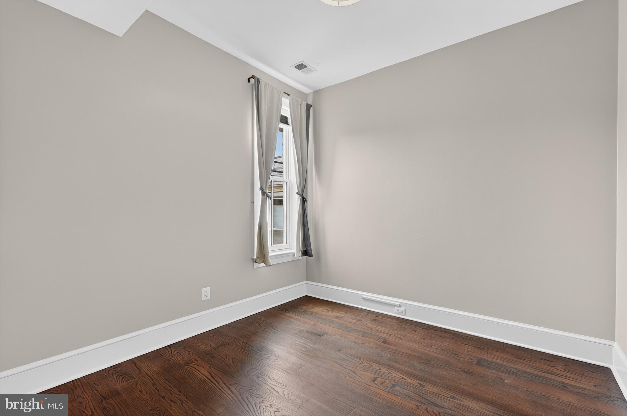 114 4th Street Northeast Washington, DC 20002 - Photo 21 of 40 a view of an empty room with wooden floor and a window