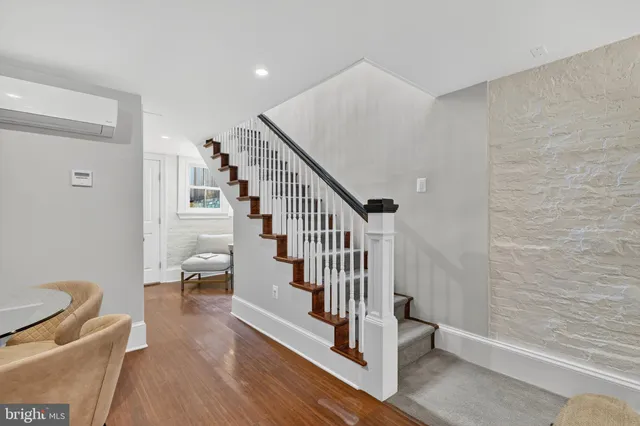 a view of entryway and hall with wooden floor