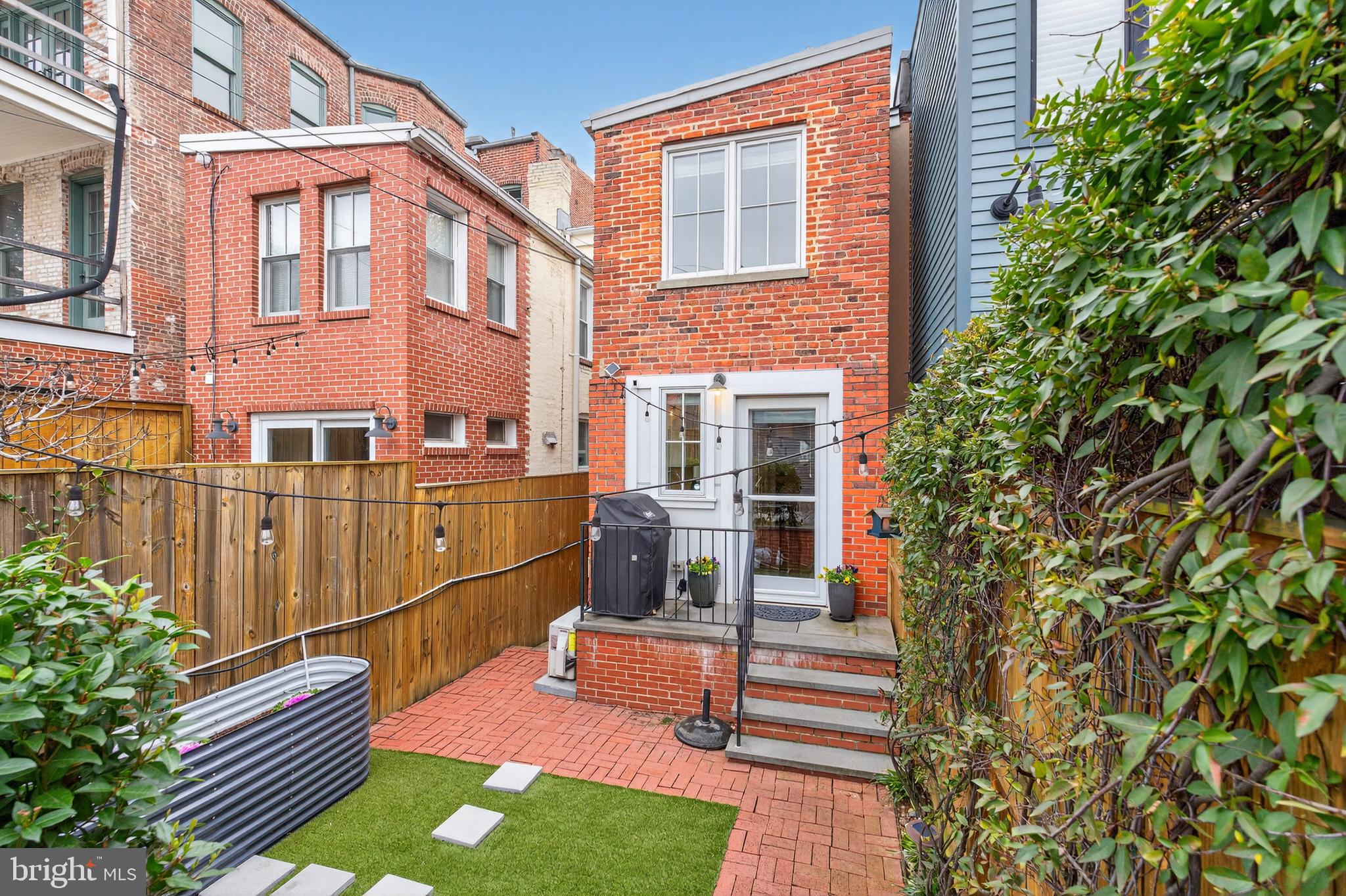 114 4th Street Northeast Washington, DC 20002 - Photo 35 of 40 a backyard of a house with barbeque oven and plants