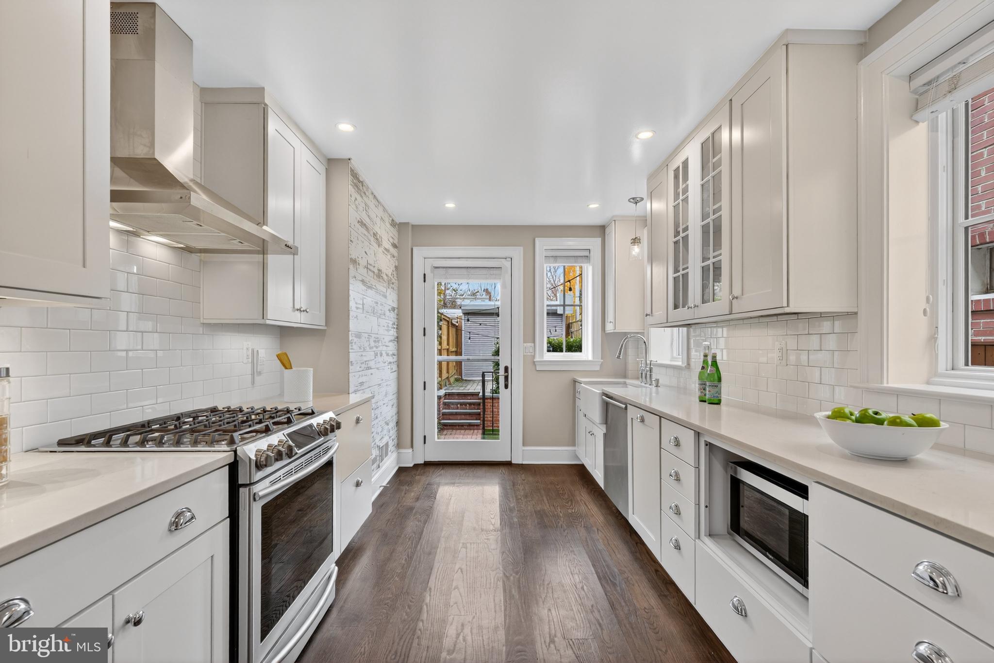 114 4th Street Northeast Washington, DC 20002 - Photo 9 of 40 a kitchen with stainless steel appliances a sink window and cabinets