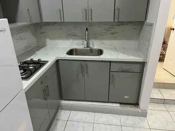 a kitchen with a sink and cabinets
