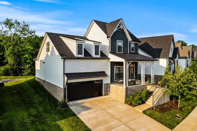 a front view of a house with a garden