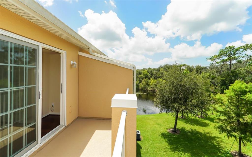 7339 Black Walnut Way Lakewood Ranch, FL 34202 - Photo 13 of 27 a front view of a house with garden