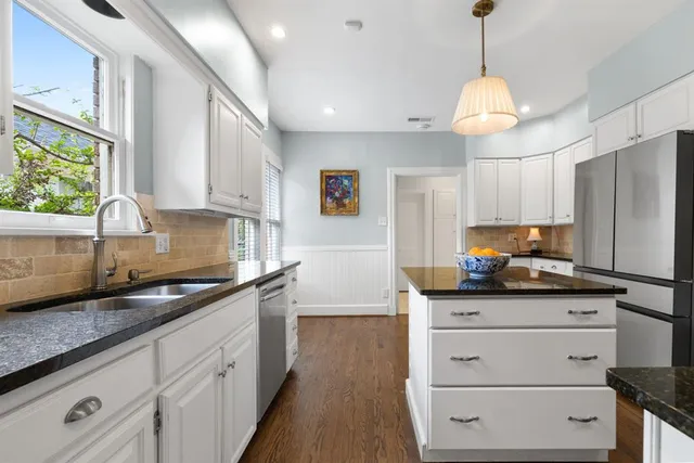 a kitchen with granite countertop a sink and a stove