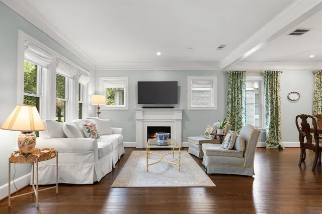 a living room with fireplace furniture and a flat screen tv