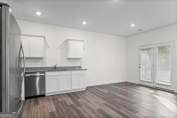 a kitchen with stainless steel appliances granite countertop a stove and a refrigerator