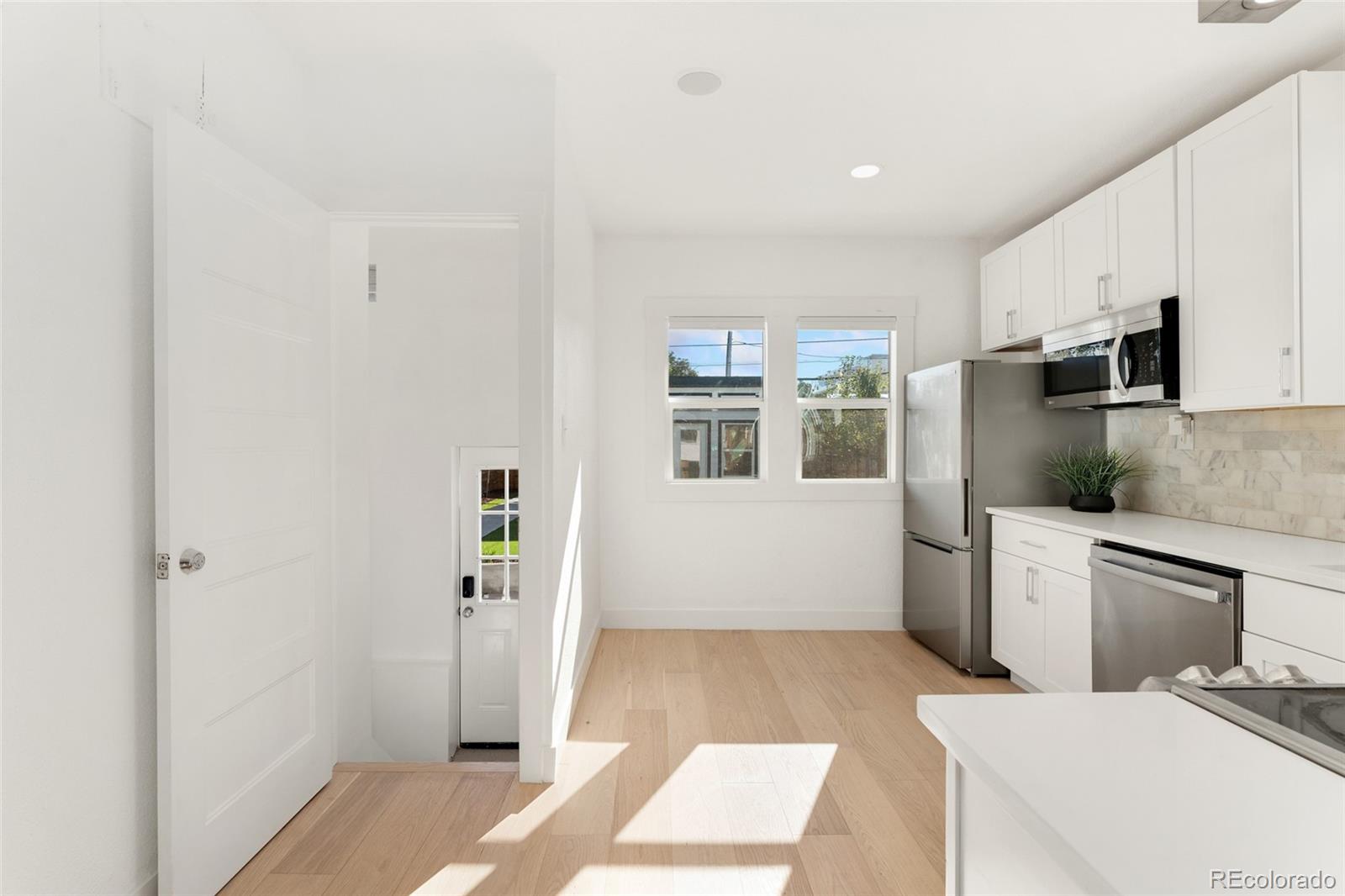 1528 Harrison Street Denver, CO 80206 - Photo 11 of 45 a room with a white bed furniture and a window