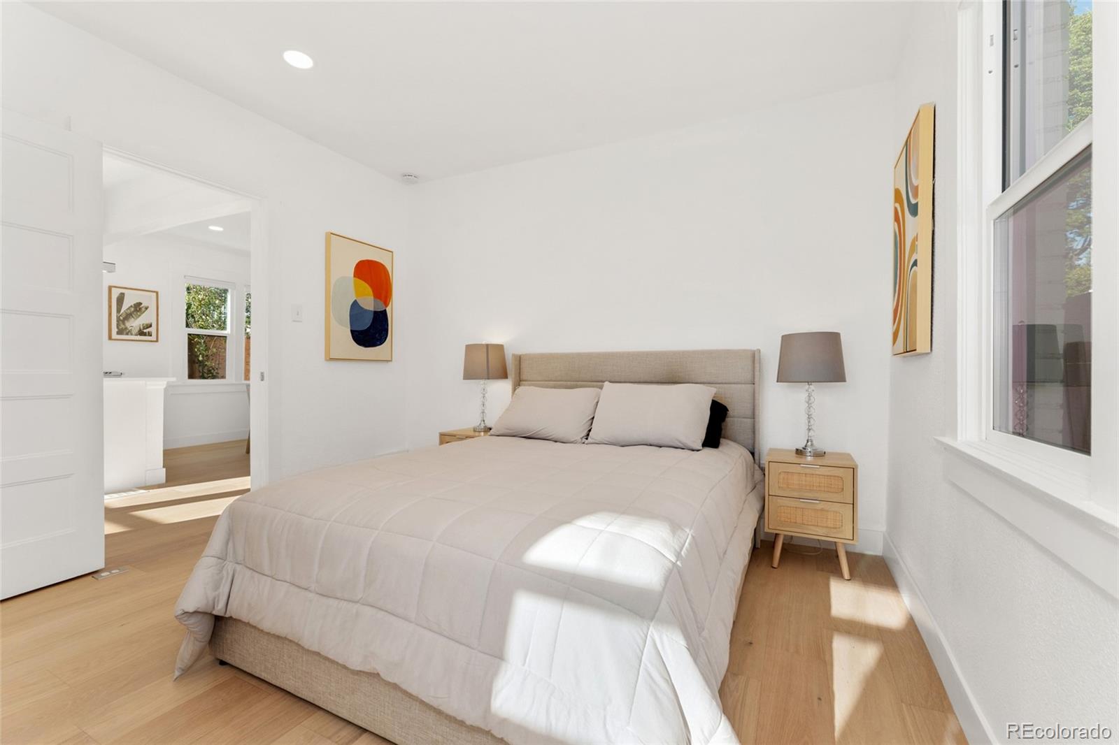 1528 Harrison Street Denver, CO 80206 - Photo 16 of 45 a bedroom with a bed and painting on the wall