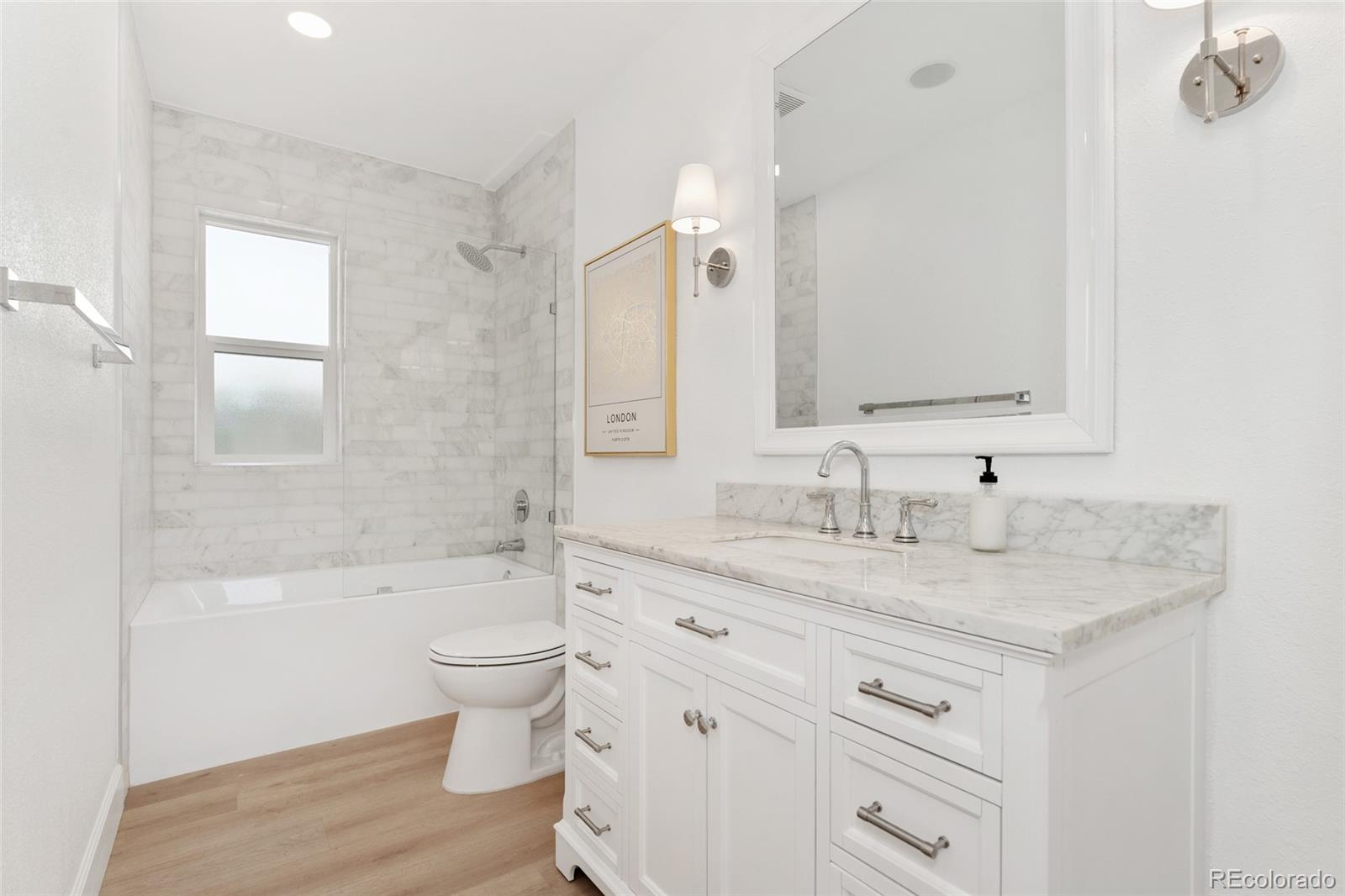 1528 Harrison Street Denver, CO 80206 - Photo 17 of 45 a bathroom with a granite countertop sink toilet and shower