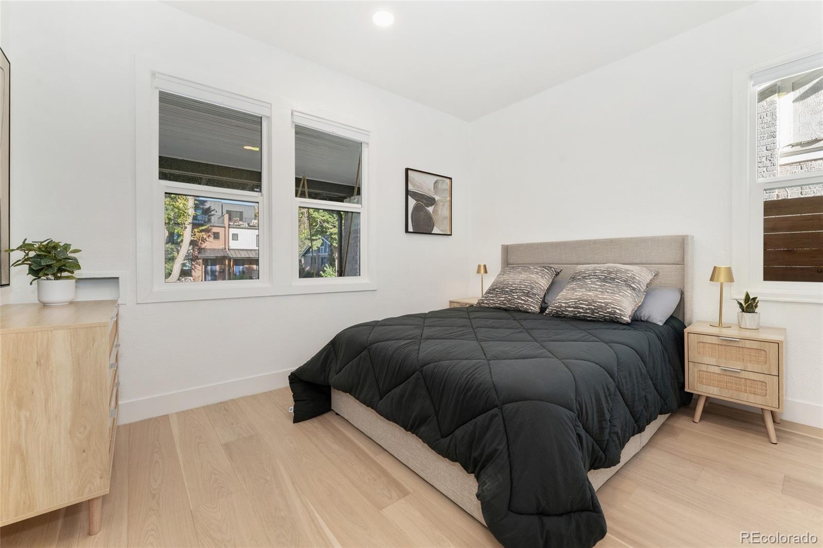 1528 Harrison Street Denver, CO 80206 - Photo 19 of 45 a bedroom with a bed and a window