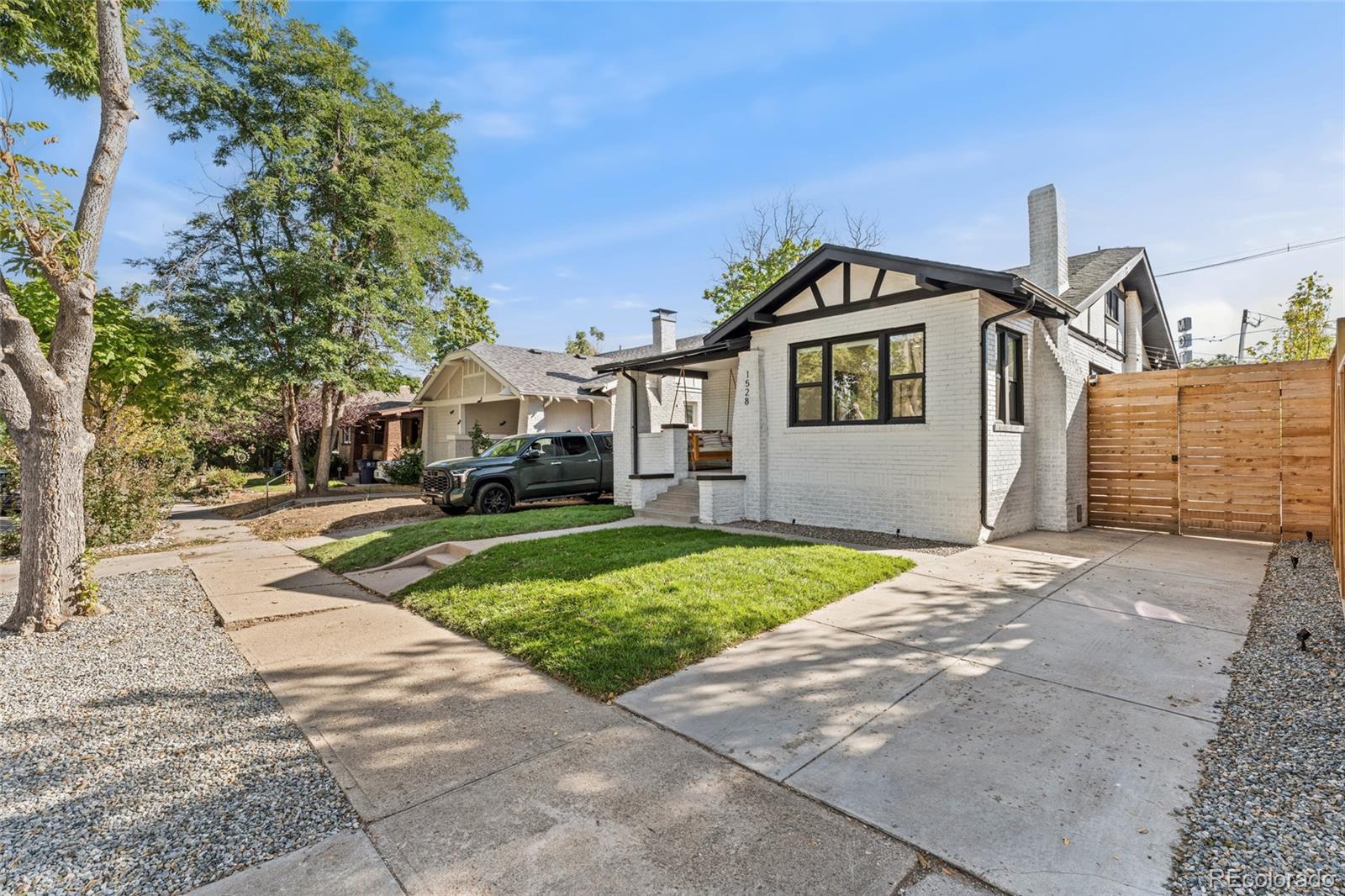 1528 Harrison Street Denver, CO 80206 - Photo 2 of 45 a front view of a house with a yard