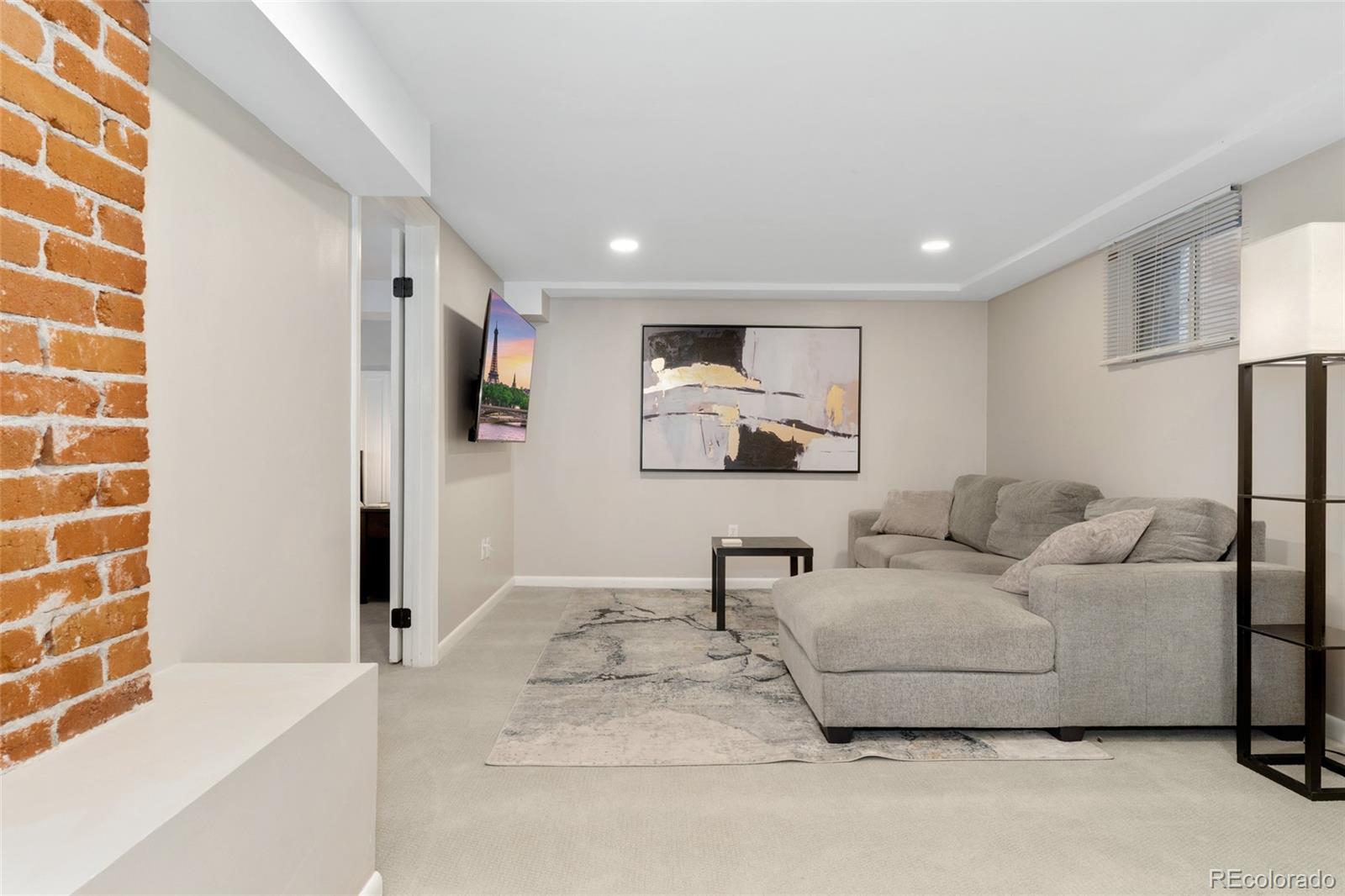 1528 Harrison Street Denver, CO 80206 - Photo 25 of 45 a living room with furniture and a painting on the wall