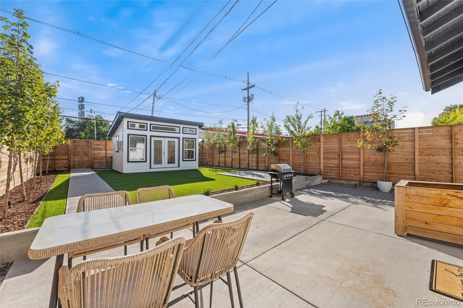 1528 Harrison Street Denver, CO 80206 - Photo 36 of 45 a view of a patio with a table and chairs under an umbrella