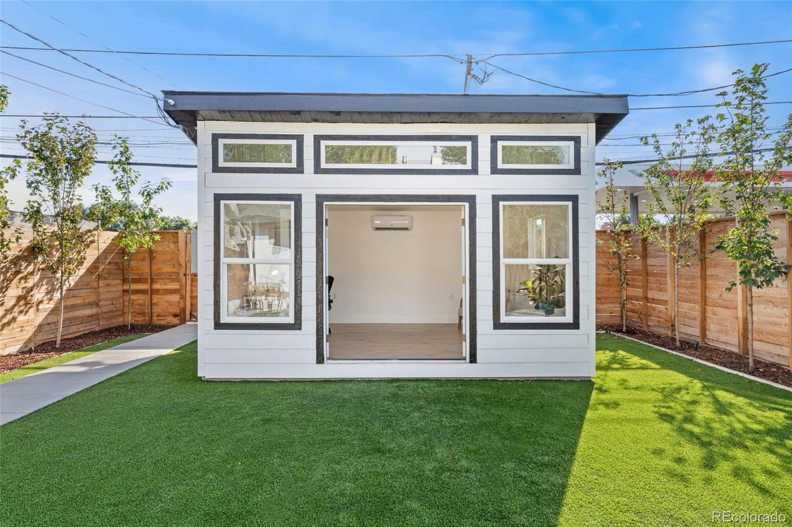 1528 Harrison Street Denver, CO 80206 - Photo 38 of 45 a front view of a house with a yard