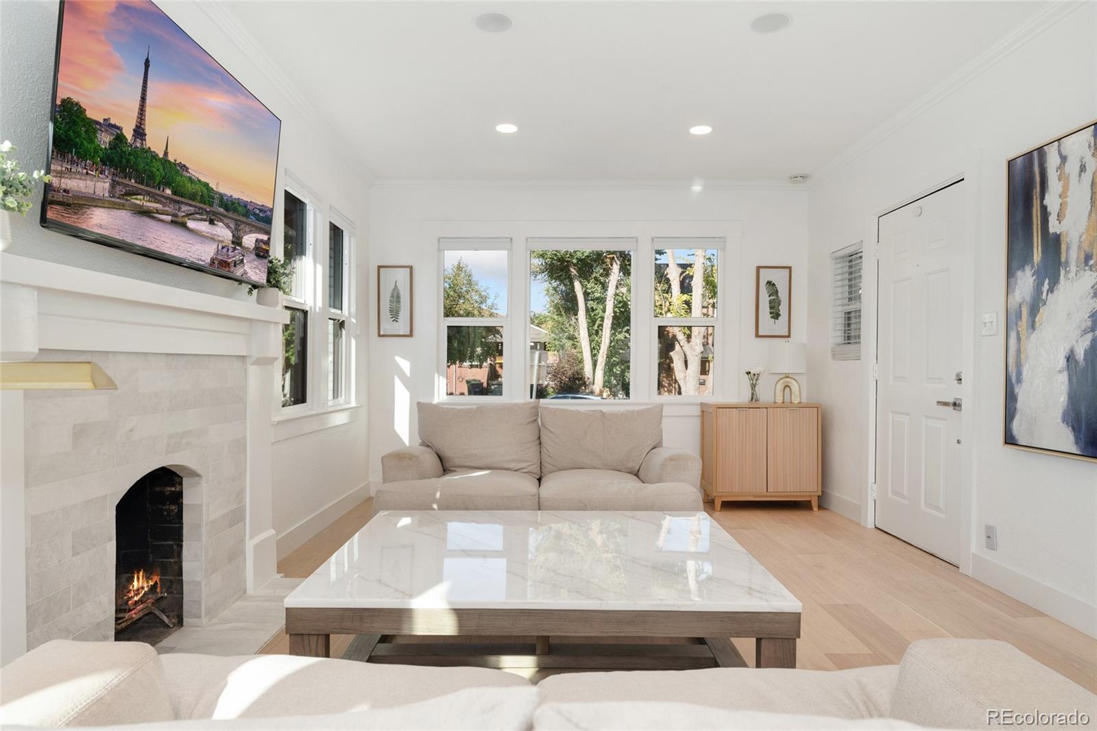1528 Harrison Street Denver, CO 80206 - Photo 4 of 45 a living room with furniture and a fireplace