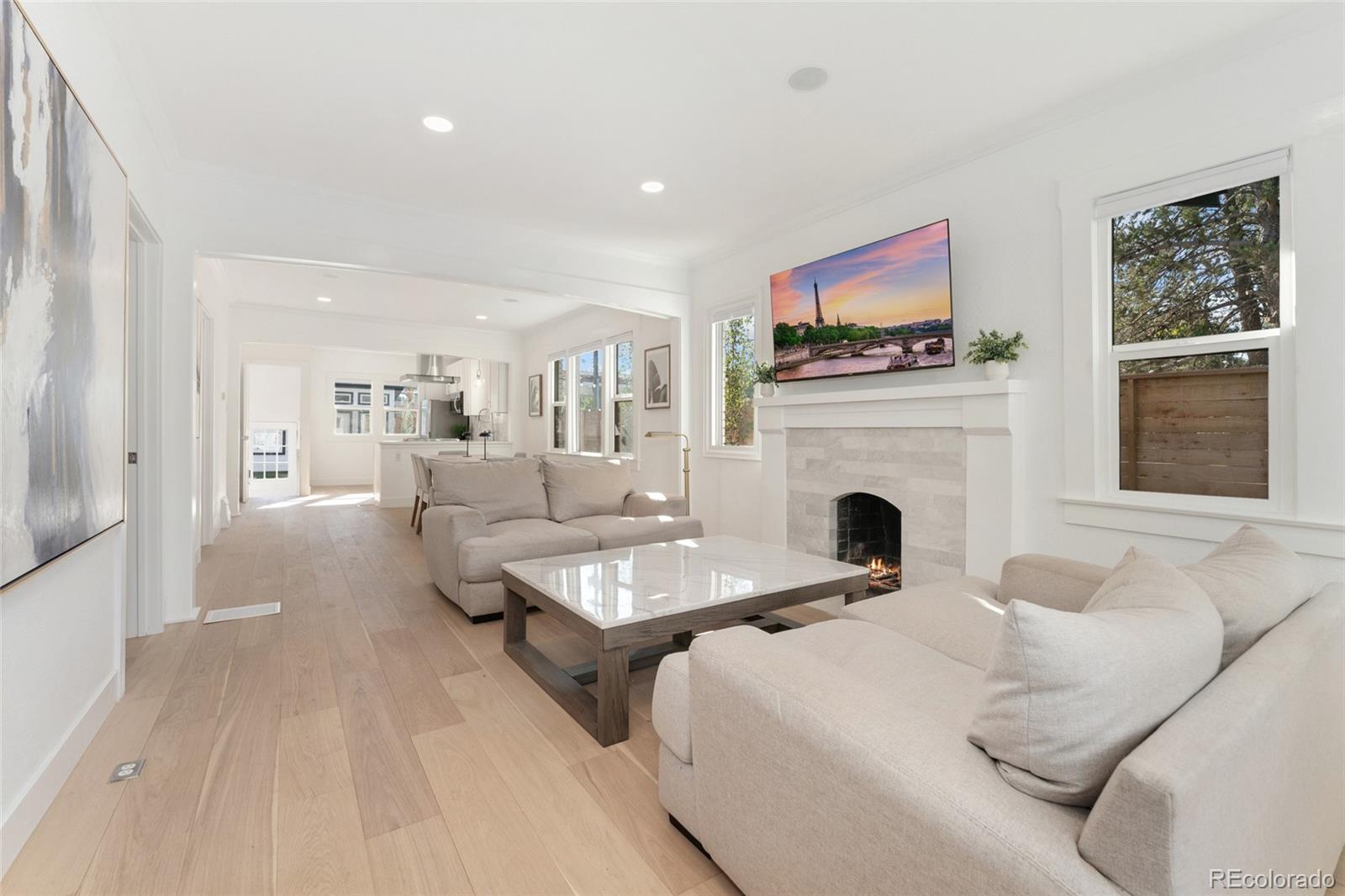 1528 Harrison Street Denver, CO 80206 - Photo 5 of 45 a living room with furniture a fireplace and a flat screen tv