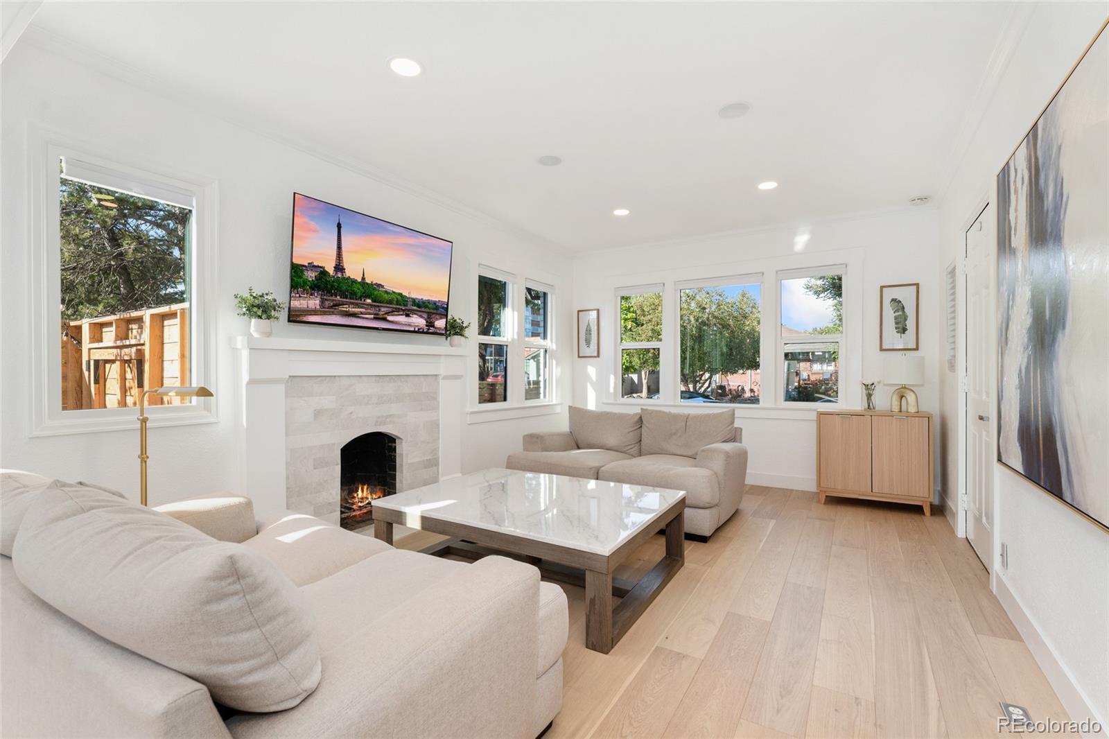 1528 Harrison Street Denver, CO 80206 - Photo 6 of 45 a living room with furniture a fireplace and a large window