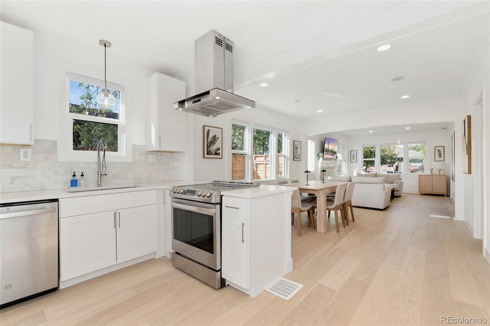 1528 Harrison Street Denver, CO 80206 - Photo 9 of 45 a kitchen with a sink stainless steel appliances and cabinets