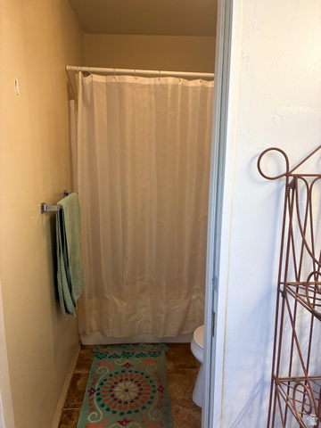 297 West Bricker Road Draper, UT 84020 - Photo 11 of 25 Bathroom with shower / tub combo and dark tile patterned flooring