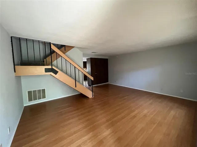a kitchen with granite countertop a refrigerator and a sink