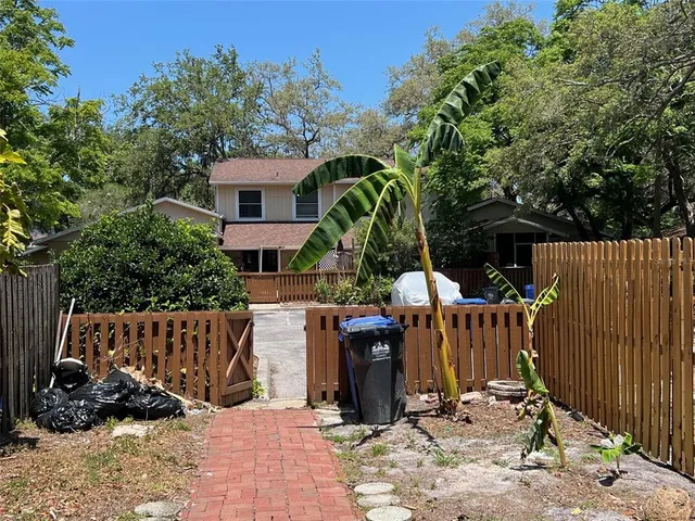 a view of a chairs and table in the backyard
