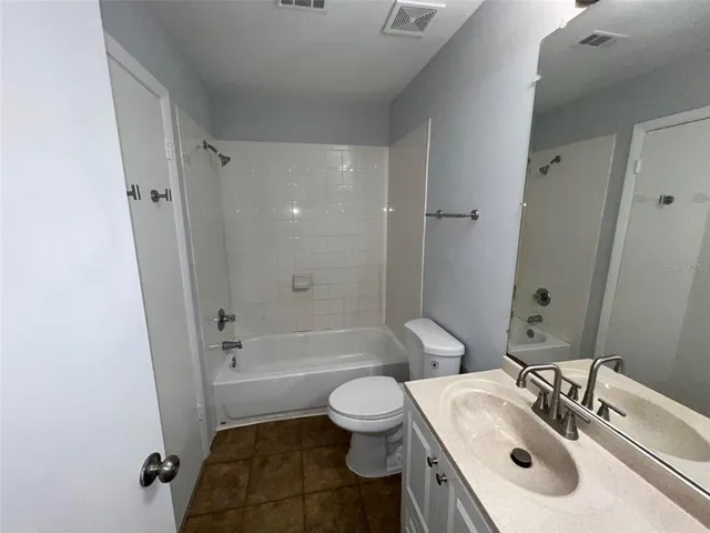a bathroom with a sink toilet tub and shower