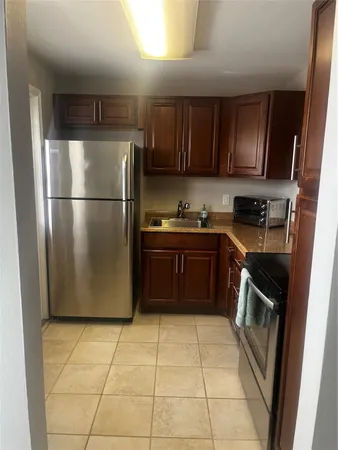 a kitchen with a stove top oven and cabinets