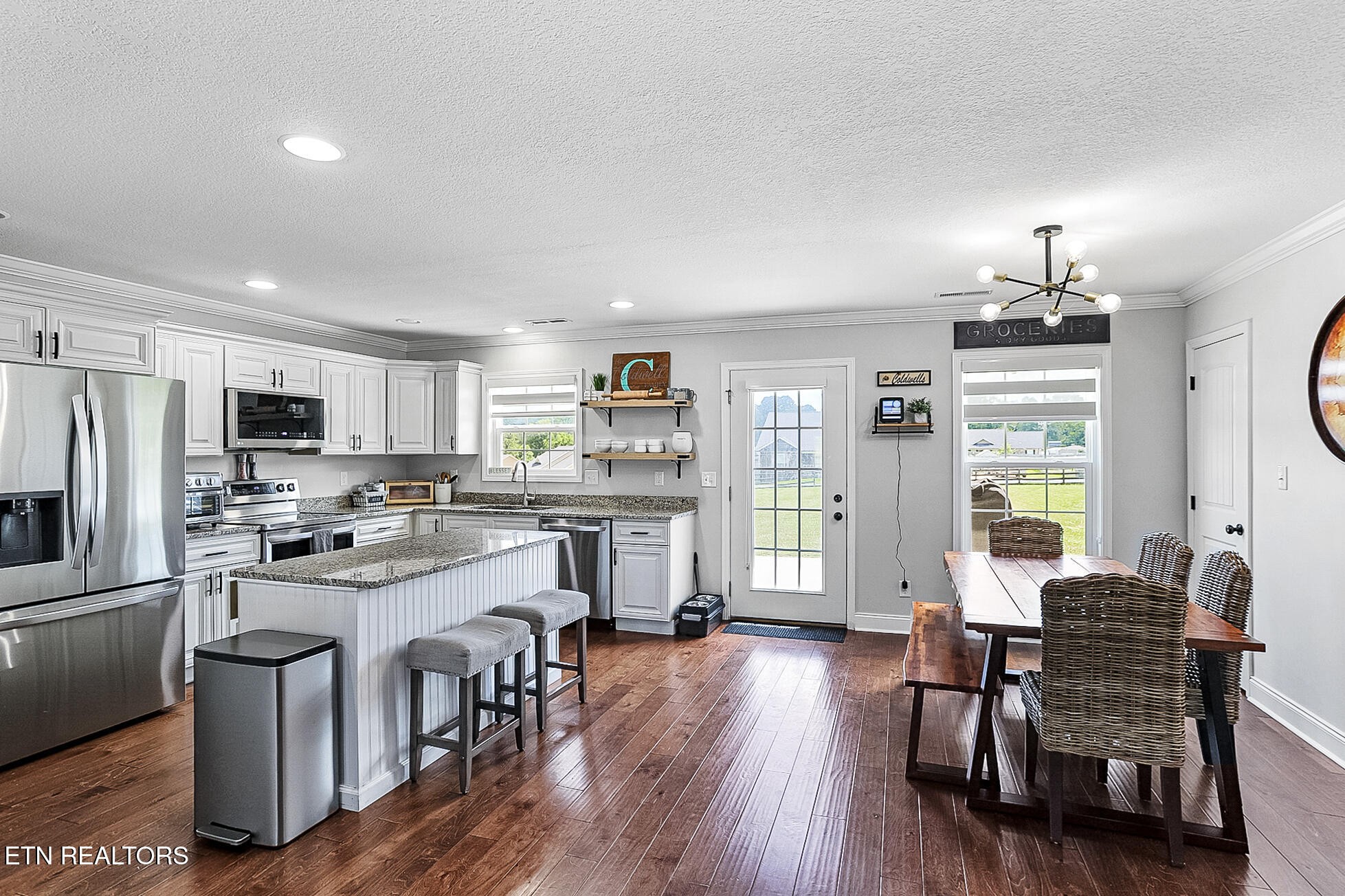 437 Covenant Way Seymour, TN 37865 - Photo 14 of 41 a kitchen with a dining table chairs refrigerator and cabinets