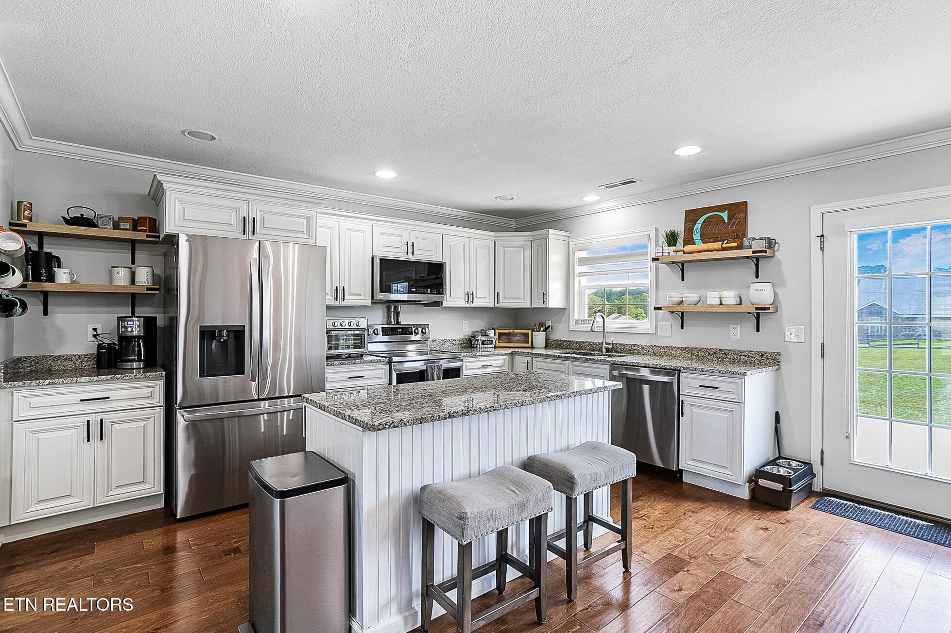 437 Covenant Way Seymour, TN 37865 - Photo 5 of 41 a kitchen with a refrigerator a stove top oven a sink dishwasher and white cabinets with wooden floor