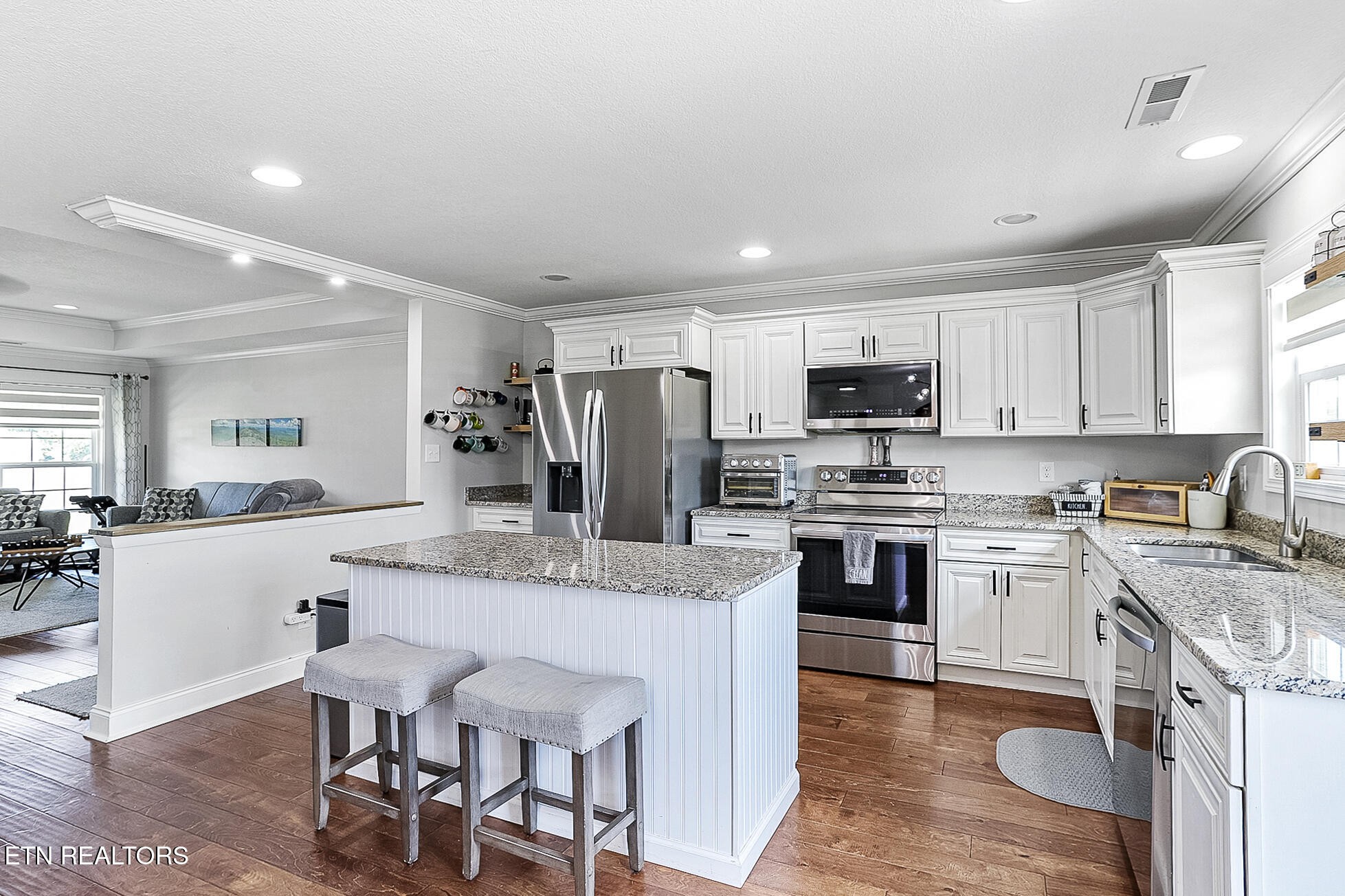437 Covenant Way Seymour, TN 37865 - Photo 7 of 41 a kitchen with a stove a sink a dining table and chairs