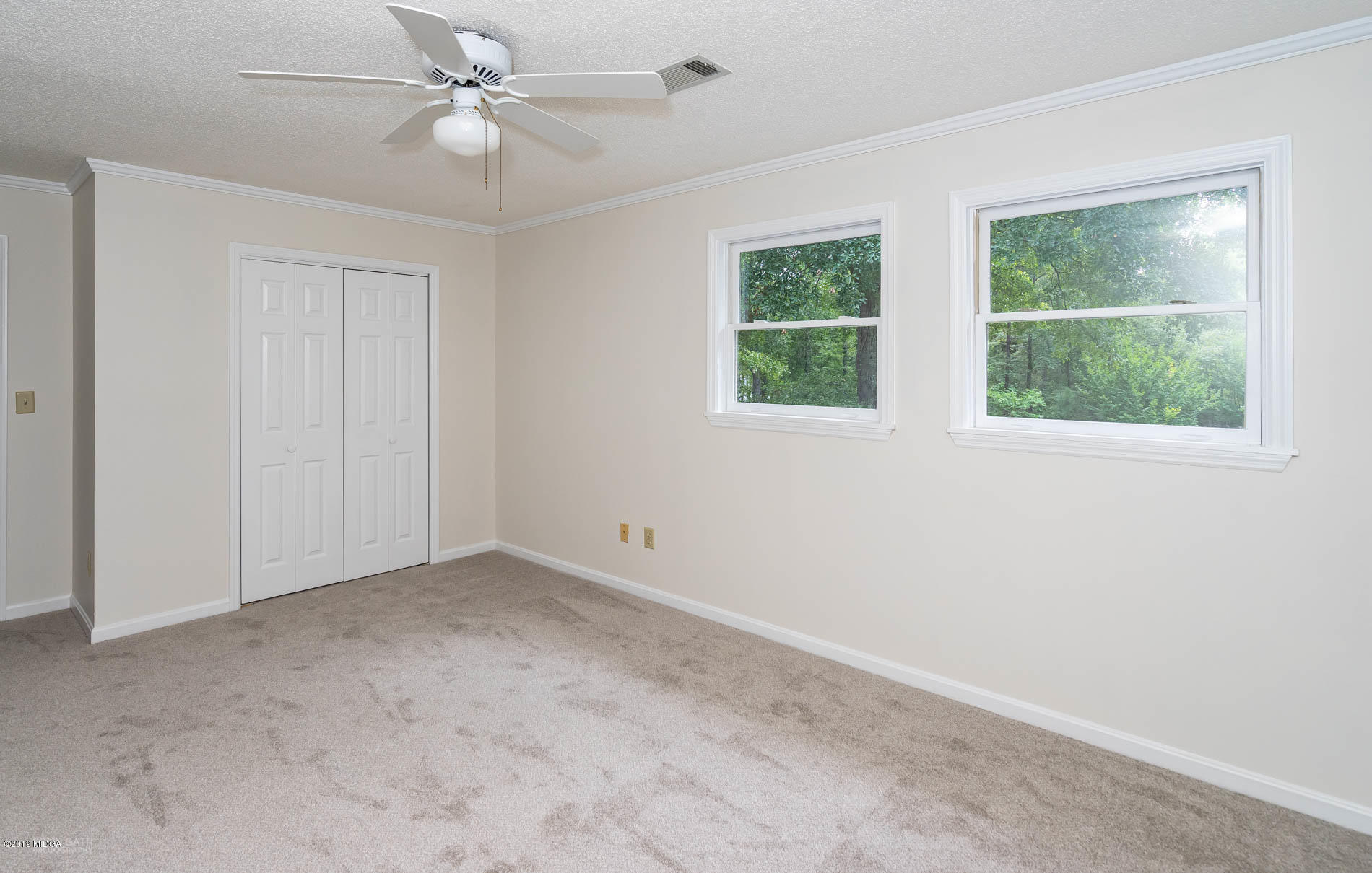 1041 Pate Road Juliette, GA 31046 - Photo 12 of 16 an empty room with windows and fan