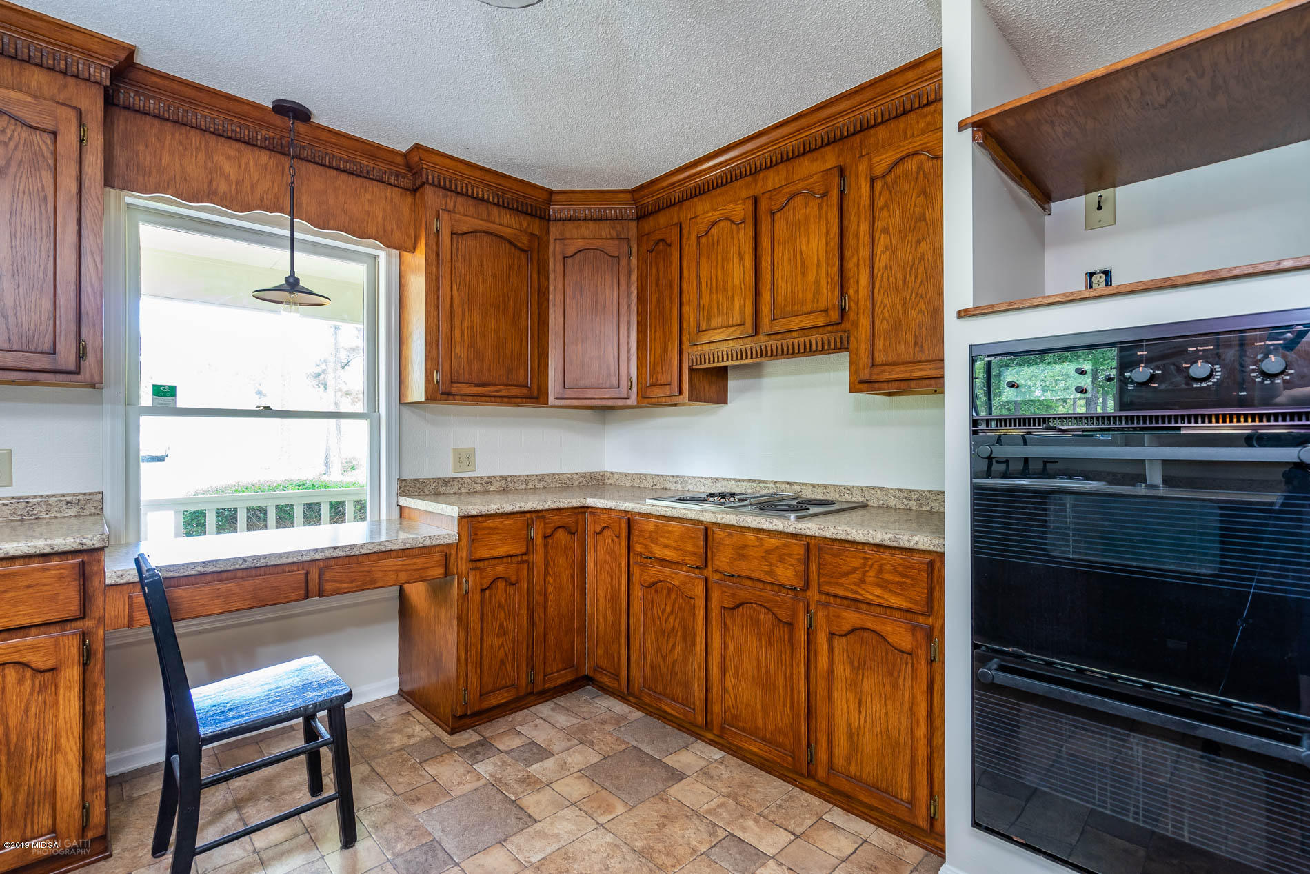 1041 Pate Road Juliette, GA 31046 - Photo 6 of 16 a kitchen with stainless steel appliances granite countertop a stove a sink and a microwave