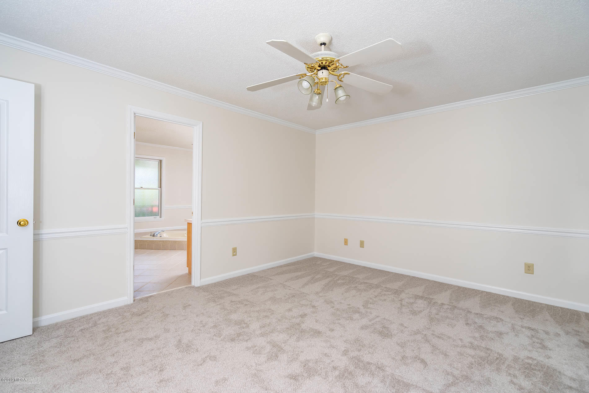 1041 Pate Road Juliette, GA 31046 - Photo 9 of 16 an empty room with a chandelier fan and windows