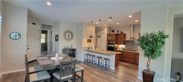 a room with furniture a clock and a potted plant