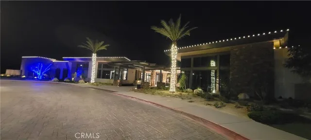 a dining room with furniture a chandelier and view of kitchen