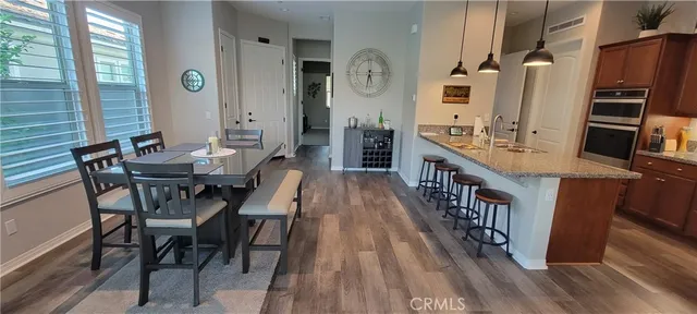 a dining room with furniture and wooden floor